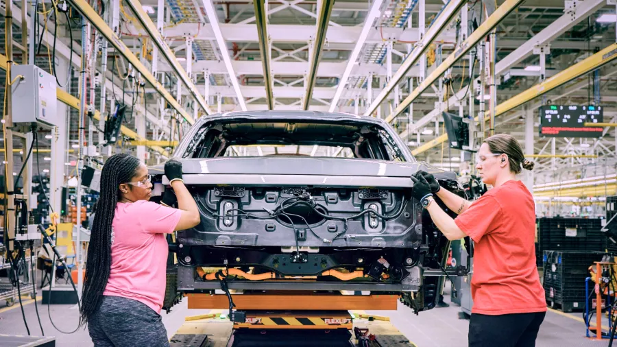 Two women assembling a truck